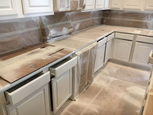 Prep For Spraying Cabinets. Everything that's not being painted is covered to prevent getting unwanted paint.